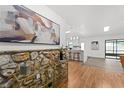 Stylish entryway with stone accent wall, decorative art, and an open floor plan at 221 W Berkshire Cir, Longwood, FL 32779