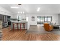 Open-concept living space with breakfast bar, tile backsplash and modern furnishings at 221 W Berkshire Cir, Longwood, FL 32779