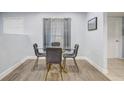 Elegant dining room with a glass table and gray chairs, showcasing neutral decor at 2743 Grandola Dr, Orlando, FL 32811
