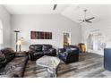 Spacious living room with high ceilings, a ceiling fan, and comfortable leather sofas at 30837 Westridge Ter, Sorrento, FL 32776
