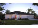 Charming single-story home with a well-manicured lawn and beautiful landscaping at 313 Marquee Dr, Kissimmee, FL 34758