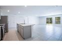 Modern kitchen with an island, stainless steel appliances, and an open concept layout at 313 Marquee Dr, Kissimmee, FL 34758