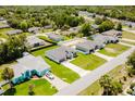 Aerial view of single Gathering home with an extended driveway and lush green lawn at 3324 Sw 137Th Loop, Ocala, FL 34473