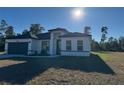 Beautiful one-story home featuring a lawn and a two-car garage at 3324 Sw 137Th Loop, Ocala, FL 34473