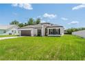 Charming single-story home featuring crisp white exterior, a driveway, and manicured lawn at 3324 Sw 137Th Loop, Ocala, FL 34473