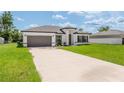 This inviting home offers a two-car garage and well manicured landscaping at 3324 Sw 137Th Loop, Ocala, FL 34473