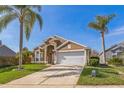Charming one-story home with a two-car garage, and manicured lawn at 3814 Aiden Pl, Apopka, FL 32703