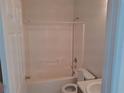 Clean bathroom featuring a shower-tub combination, toilet, and single sink at 619 Raven Ct, Poinciana, FL 34759