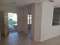 Bright and airy foyer features tile flooring and ample natural light from the front door at 619 Raven Ct, Poinciana, FL 34759