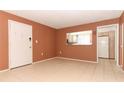 A cozy living room with a pass through view of the adjacent kitchen and a white front door at 626 Orange Dr # 242, Altamonte Springs, FL 32701