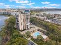 Aerial view showcasing the condo, pool, and surrounding neighborhood including a lake nearby at 7550 Hinson St # 11, Orlando, FL 32819