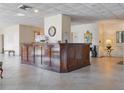 Interior lobby with a dark wood reception desk, tile floors, and elegant decor at 7550 Hinson St # 11C, Orlando, FL 32819