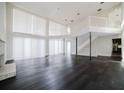 Bright living room with high ceilings, balcony, fireplace and hardwood floors at 8322 Lake Lucy Dr, Orlando, FL 32818