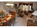 Warm and inviting living room with dining area, plush seating, and decorative plants at 913 Henley Cir, Davenport, FL 33896