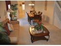 Comfortable living room and dining space with plush sofa, wooden furniture, and staircase at 913 Henley Cir, Davenport, FL 33896
