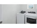 The laundry area features a white washer and dryer with white walls and trim at 993 King Parc Rd, Orange City, FL 32763