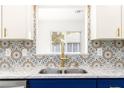 Bright kitchen with modern countertops, decorative backsplash, and stainless steel sink and faucet at 11643 Sw 137Th Loop, Dunnellon, FL 34432