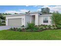 Charming home with a gray garage door, a gray brick paver walkway, and a well-maintained, landscaped lawn at 1251 Cresswind Blvd, Deland, FL 32724