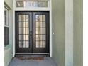 Elegant double-door entry with glass panels and a modern electronic lock system at 1368 Falconwood Ct, Apopka, FL 32712