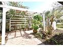 Cozy backyard with pergola creates an inviting outdoor space for relaxing and entertaining surrounded by lush landscape at 1611 Chestnut Ave, Winter Park, FL 32789