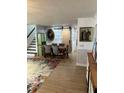 Dining room with farmhouse table, barn door, hardwood floors, and designer wallpaper and paint at 1611 Chestnut Ave, Winter Park, FL 32789