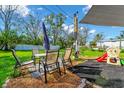 Backyard seating area featuring patio set, play area, and shade at 226 3Rd St, Orlando, FL 32824