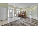 Bright dining room with wood floors, a chandelier, and an archway framing the entrance at 27 Foxhunter Flt, Ormond Beach, FL 32174