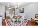 Bright dining room with hardwood floors, chandelier, and stylish furnishings at 4160 Golden Willow Cir, Apopka, FL 32712