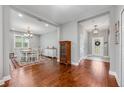 Elegant dining room with hardwood floors, chandelier, and decorative furnishings at 4160 Golden Willow Cir, Apopka, FL 32712