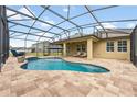 Inviting screened-in pool area featuring a custom pool and spacious patio area for entertaining at 4160 Golden Willow Cir, Apopka, FL 32712