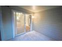 A patio or covered porch with a sliding glass door leads to the living room of a condo for sale at 5016 Park Central Dr # 2231, Orlando, FL 32839