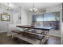 Dining room featuring a large wood table and bench seating at 525 Gentle Breeze Dr, Minneola, FL 34715