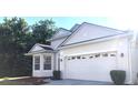 Well-maintained one-story home featuring a large two-car garage and manicured bushes at 5509 Florence Harbor Dr, Orlando, FL 32829