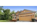 Charming single-Gathering home featuring a well-maintained lawn, neutral-colored exterior, and a spacious two-car garage at 5509 Florence Harbor Dr, Orlando, FL 32829