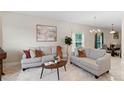 Inviting living room features neutral furnishings, stylish decor, tile floors, and ample natural light from a large window at 5509 Florence Harbor Dr, Orlando, FL 32829