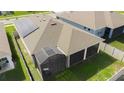Birds eye view of the home featuring solar panels, a screened-in lanai, and a fenced-in backyard at 5637 Cedar Chase Dr, St Cloud, FL 34771