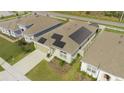 An aerial view of a home with solar panels, manicured landscaping, and a long driveway at 5637 Cedar Chase Dr, St Cloud, FL 34771