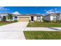 Charming single-story home with a well-manicured lawn, long driveway and a two-car attached garage at 5637 Cedar Chase Dr, St Cloud, FL 34771