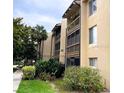 Multi-story condo building with balconies and well-maintained landscaping, offering a serene living environment at 586 Orange Dr # 114, Altamonte Springs, FL 32701