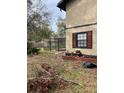 View of the backyard featuring a screened-in pool and lush landscaping and foliage at 612 Wolf Run, Winter Haven, FL 33880