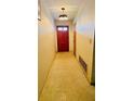 Inviting hallway featuring a solid wood front door and neutral wall color at 6429 Voltaire Dr, Orlando, FL 32809