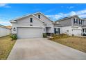 Beautiful one-story home featuring a two car garage, well-manicured lawn, and driveway at 6992 Dilly Lake Ave, Groveland, FL 34736