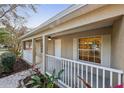 Covered front porch showcasing white railing and view into the home's living space at 820 Cypress Oak Cir, Deland, FL 32720