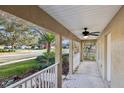 Inviting covered front porch with landscaped garden and view of neighborhood at 820 Cypress Oak Cir, Deland, FL 32720