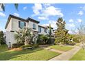 Charming two-story home with lush landscaping, a stone accent wall, and a well-maintained front yard at 8515 Morehouse Dr, Orlando, FL 32836