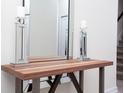 Close-up of a wood table decorated with glass ornaments and a mirror at 8988 Cabot Cliffs Dr, Champions Gate, FL 33896