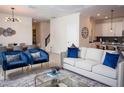 Open-concept living area with stylish furnishings and seamless flow to the dining and kitchen areas at 8988 Cabot Cliffs Dr, Champions Gate, FL 33896