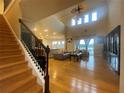 Spacious living room with high ceilings, hardwood floors, staircase, and open floor plan at 9526 Lake Hugh Dr, Gotha, FL 34734