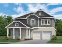 Striking two-story home showcasing a modern design, a covered porch, and a convenient two-car garage at 13062 Sunrise Harvest Dr, Winter Garden, FL 34787