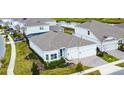 Aerial view of a single Gathering home showcasing its well-manicured lawn, screened pool, and proximity to nearby houses at 13401 Panama Beach Ct, Orlando, FL 32827